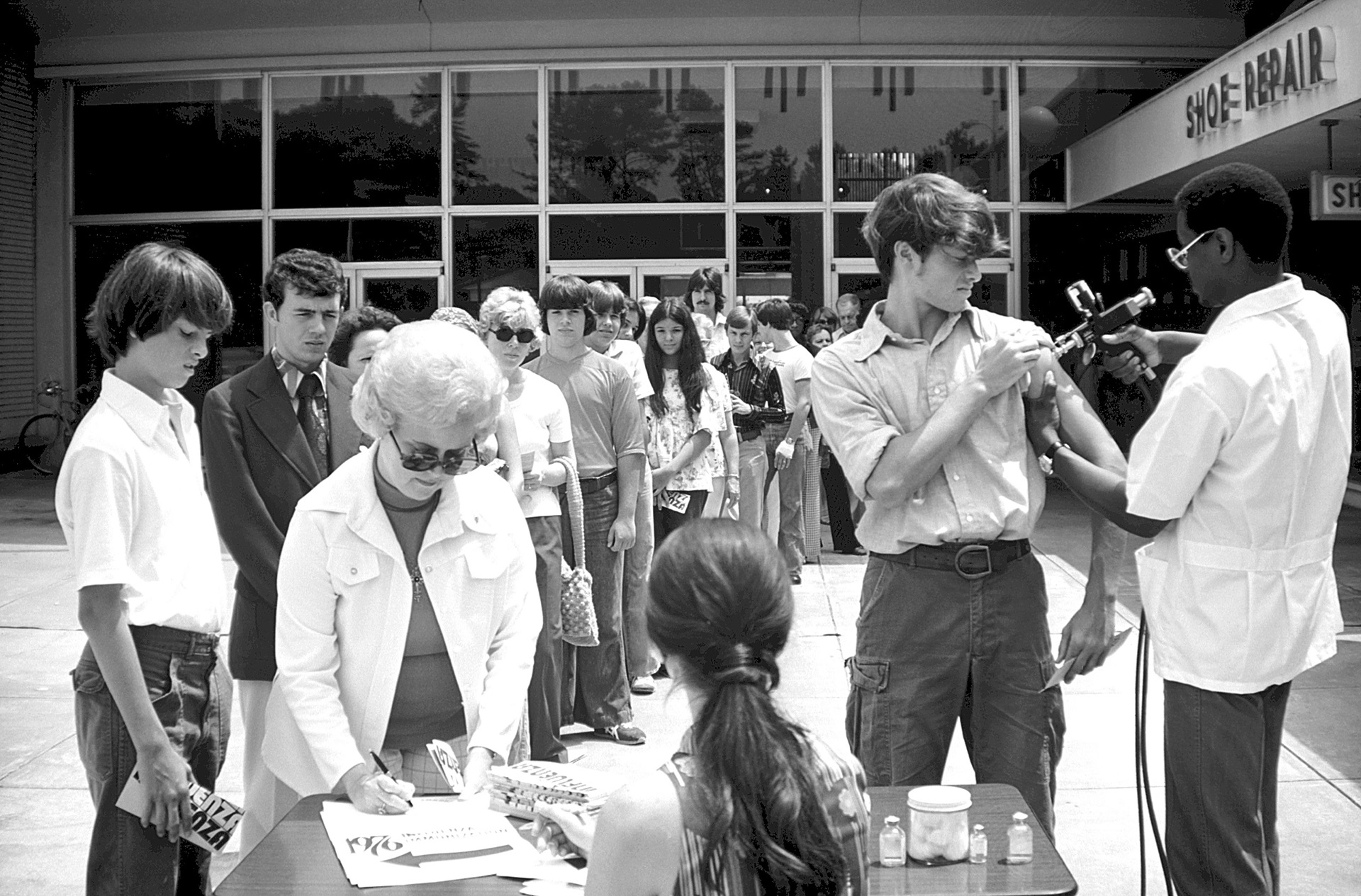 Influenza-USA-1976 A line of people awaiting Influenza vaccination.