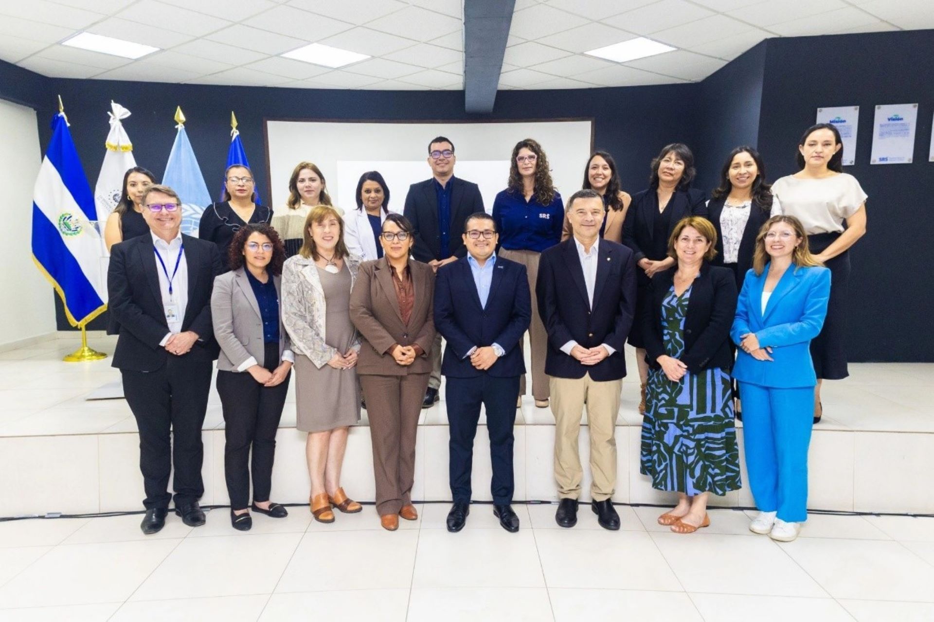 PAHO CRP WP 24-25 June 25 Groupe of people standing in front of several flags