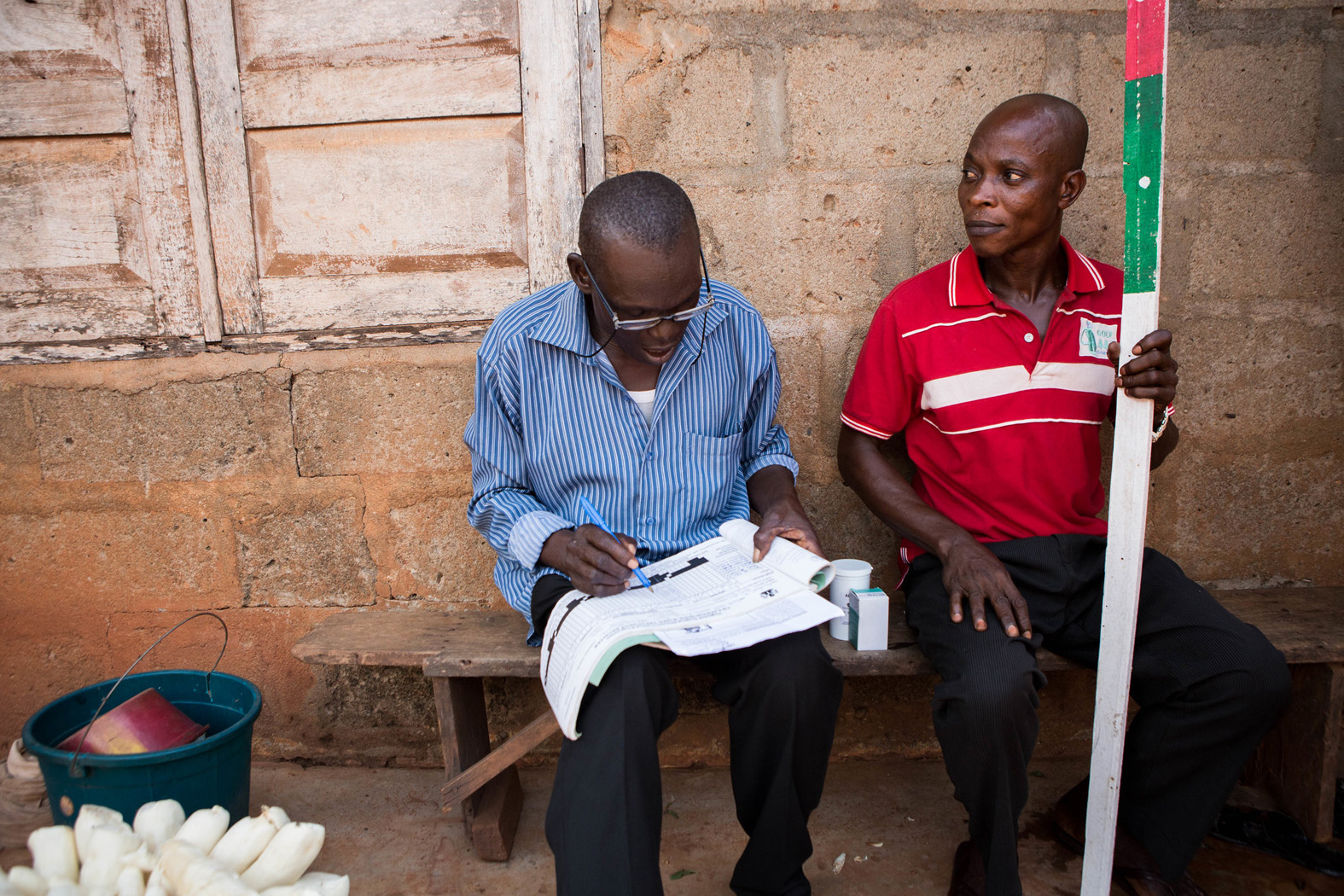 Fighting-LF-in-Cross-River-State-Nigeria-RTI-fights-NTDs Ademocha and Aidika administer medicine to prevent and treat lymphatic filariasis in Cross River State, Nigeria.