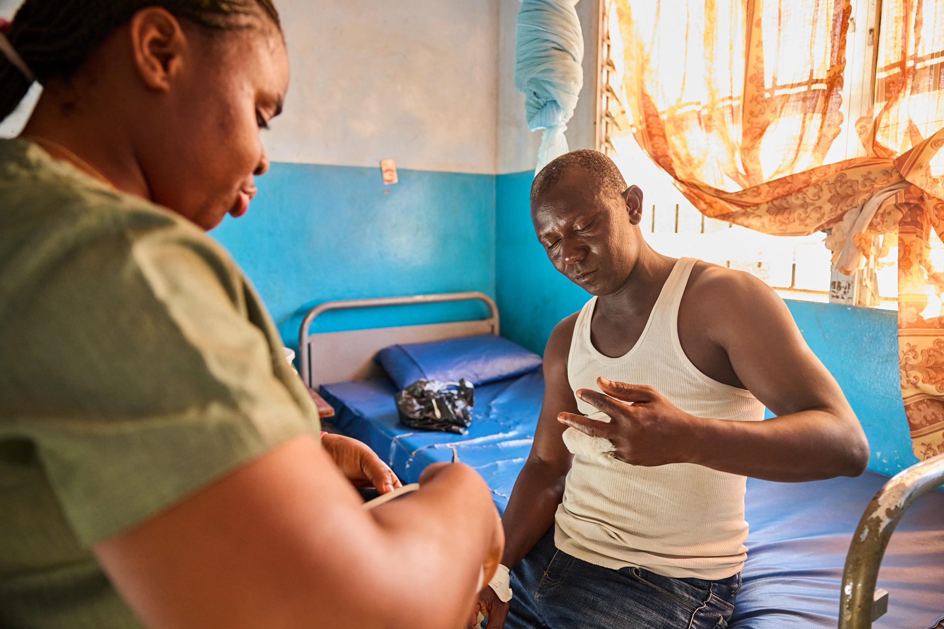 Activities on skin-related NTDs in sub-Saharan Africa-3 A nurse and a patient admitted for skin-related NTDs in a district health center in sub-Saharan Africa