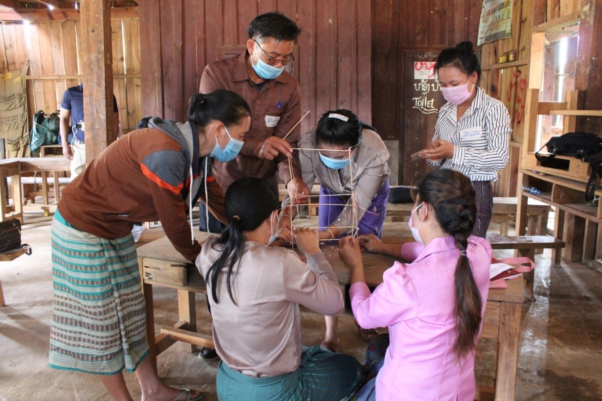 Workshop participants collaborate to build a “tower of good health”. Workshop participants collaborate to build a “tower of good health”